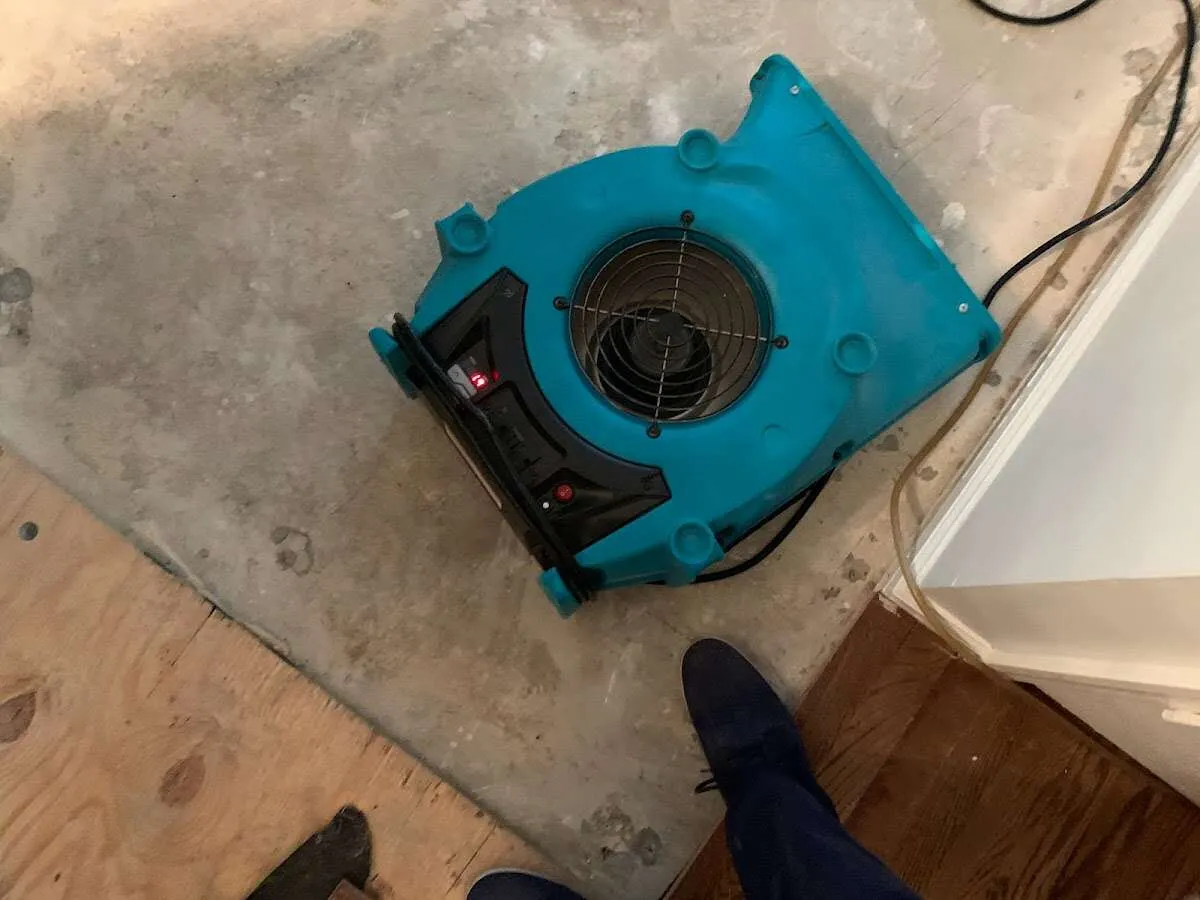 Air mover drying subfloor during Leak Detection & Repair in Northville